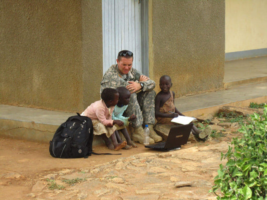 veteran soldier on nonprofit mission with indigenous children in the midst of potential vector-borne diseases